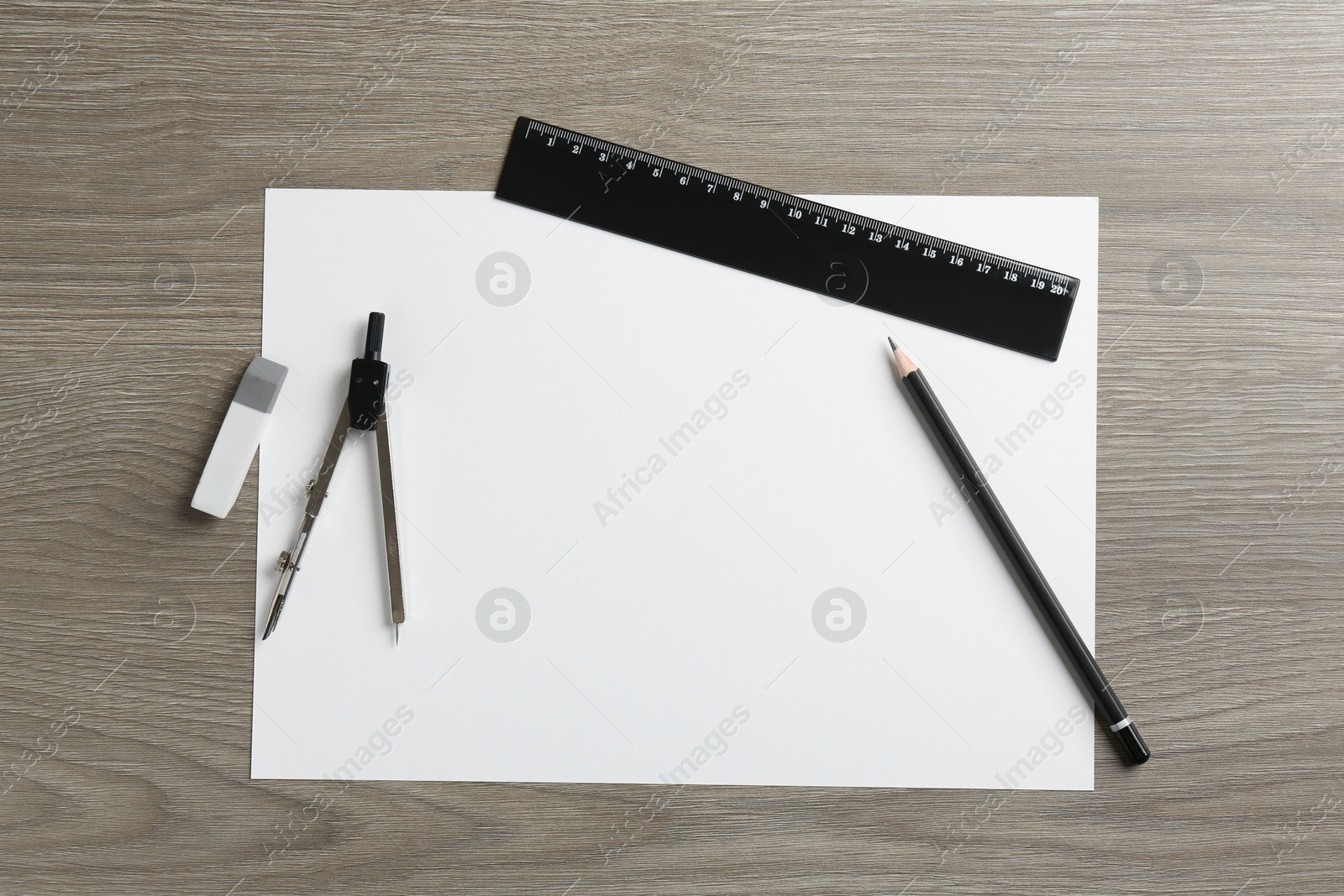 Photo of Flat lay composition with ruler and other stationery on wooden table, space for text