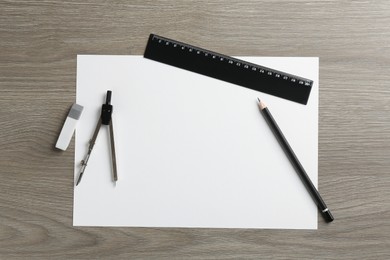 Photo of Flat lay composition with ruler and other stationery on wooden table, space for text