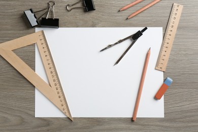 Photo of Flat lay composition with ruler and other stationery on wooden table, space for text