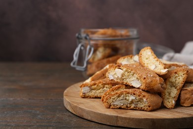 Photo of Traditional Italian almond biscuits (Cantucci) on wooden table, closeup. Space for text