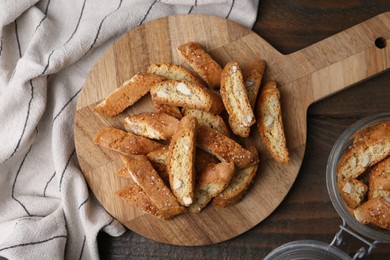 Photo of Traditional Italian almond biscuits (Cantucci) on wooden table, flat lay