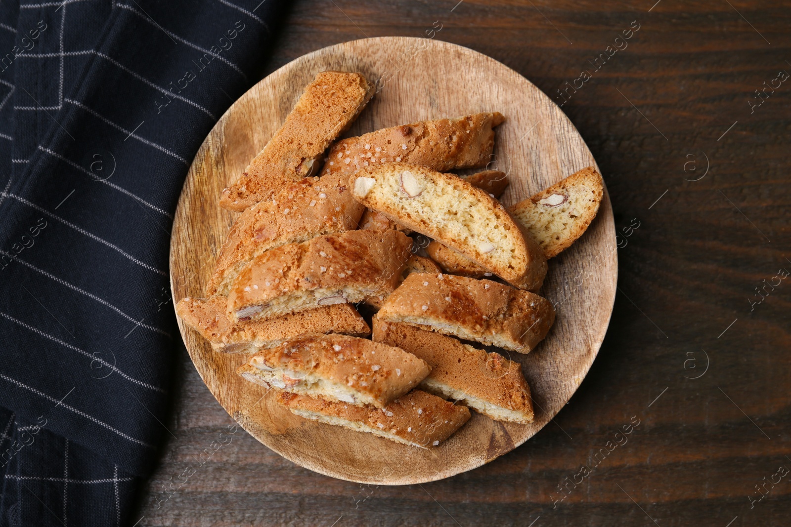 Photo of Tasty almond biscuits (Cantuccini) on wooden table, top view