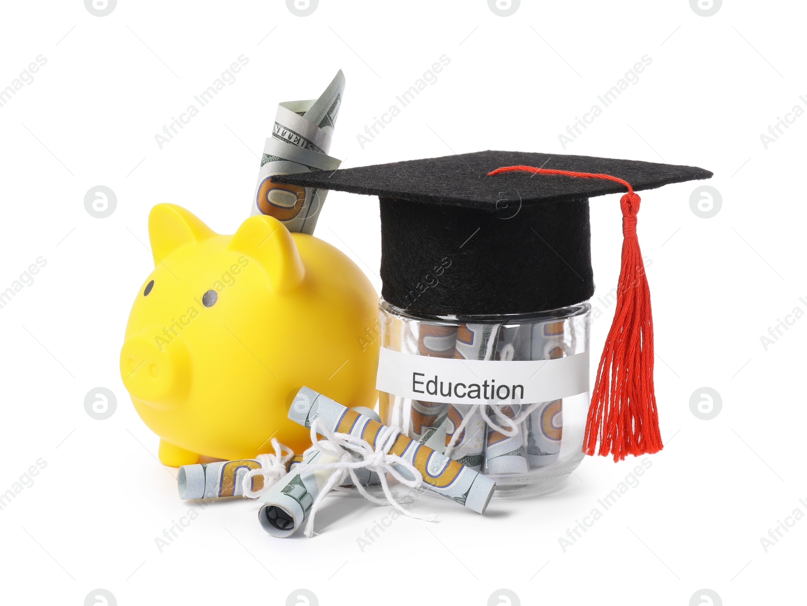 Photo of Piggy bank, graduate hat, dollar banknotes and glass jar with word Education isolated on white. Tuition payment