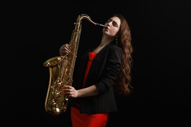 Photo of Professional musician playing saxophone on black background