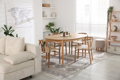 Photo of Stylish wooden table with chairs and decor indoors. Interior design