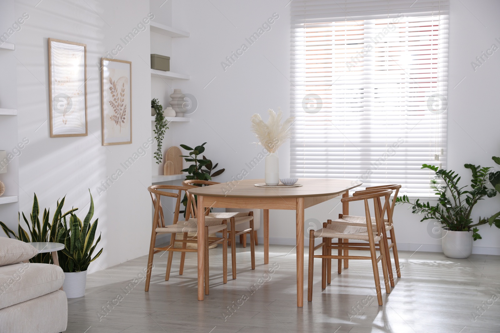 Photo of Stylish wooden table with chairs and decor indoors. Interior design