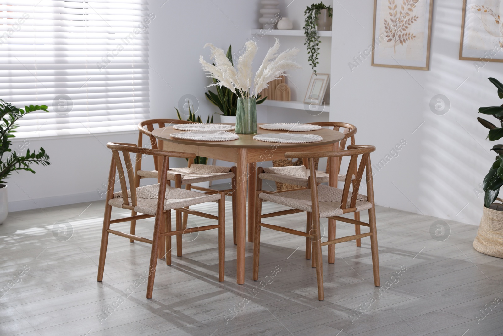 Photo of Stylish wooden table with chairs and decor indoors. Interior design