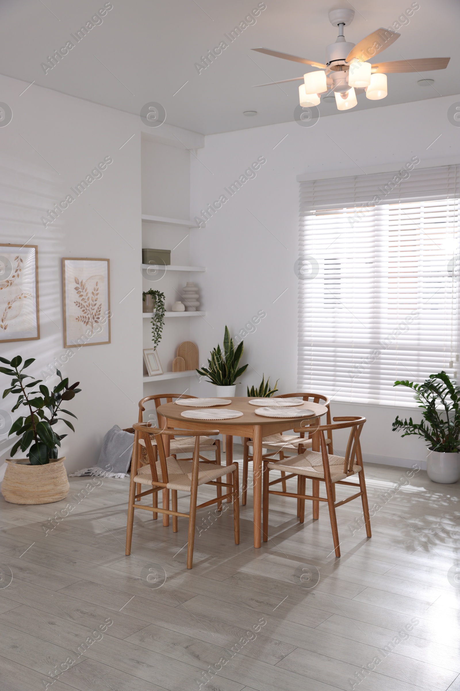 Photo of Stylish wooden table with chairs and decor indoors. Interior design