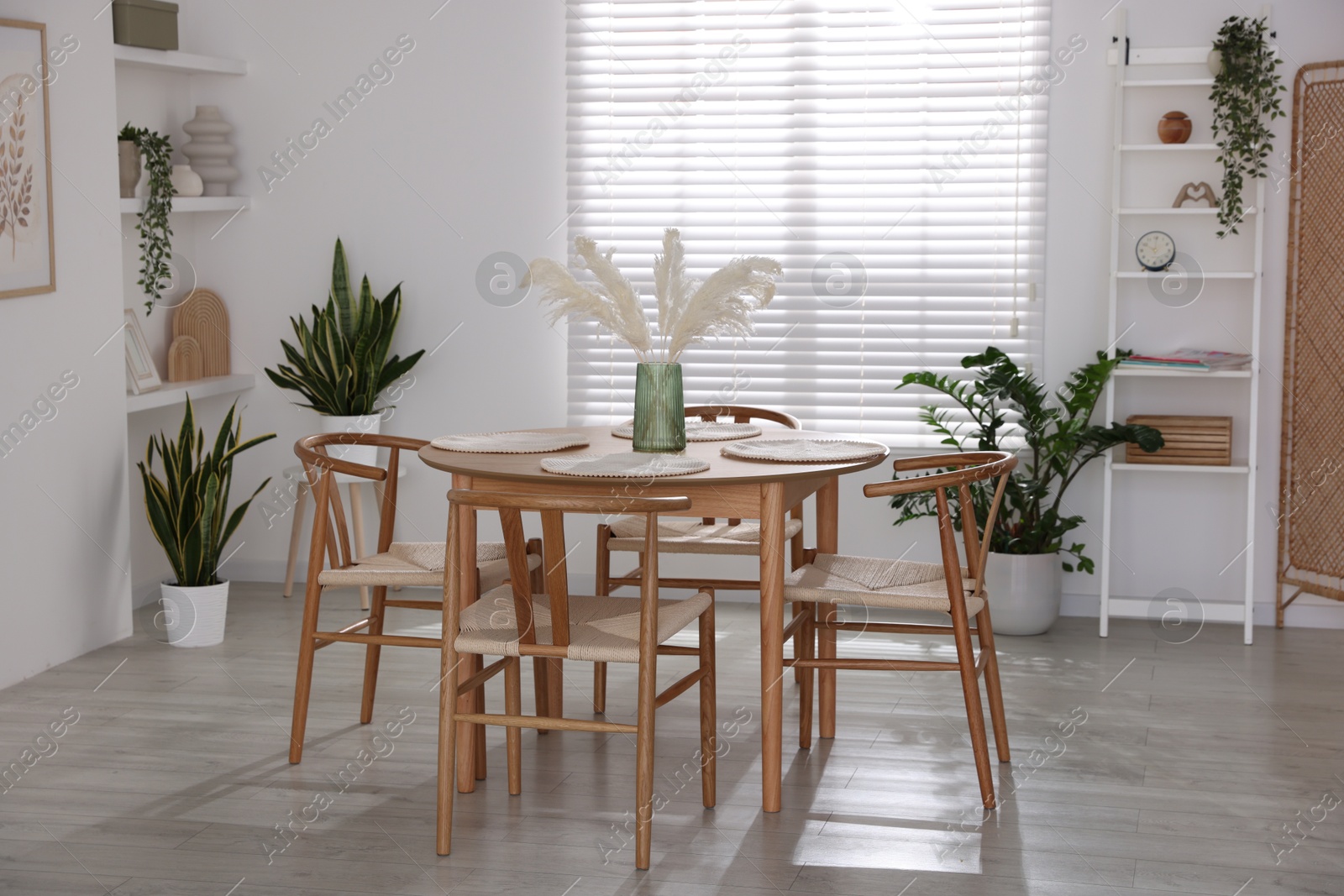 Photo of Stylish wooden table with chairs and decor indoors. Interior design