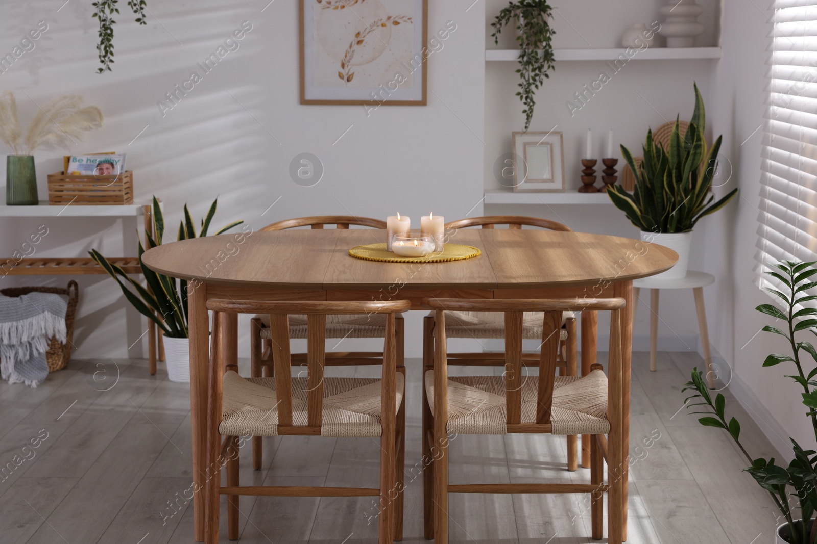 Photo of Stylish wooden table with chairs and decor indoors. Interior design