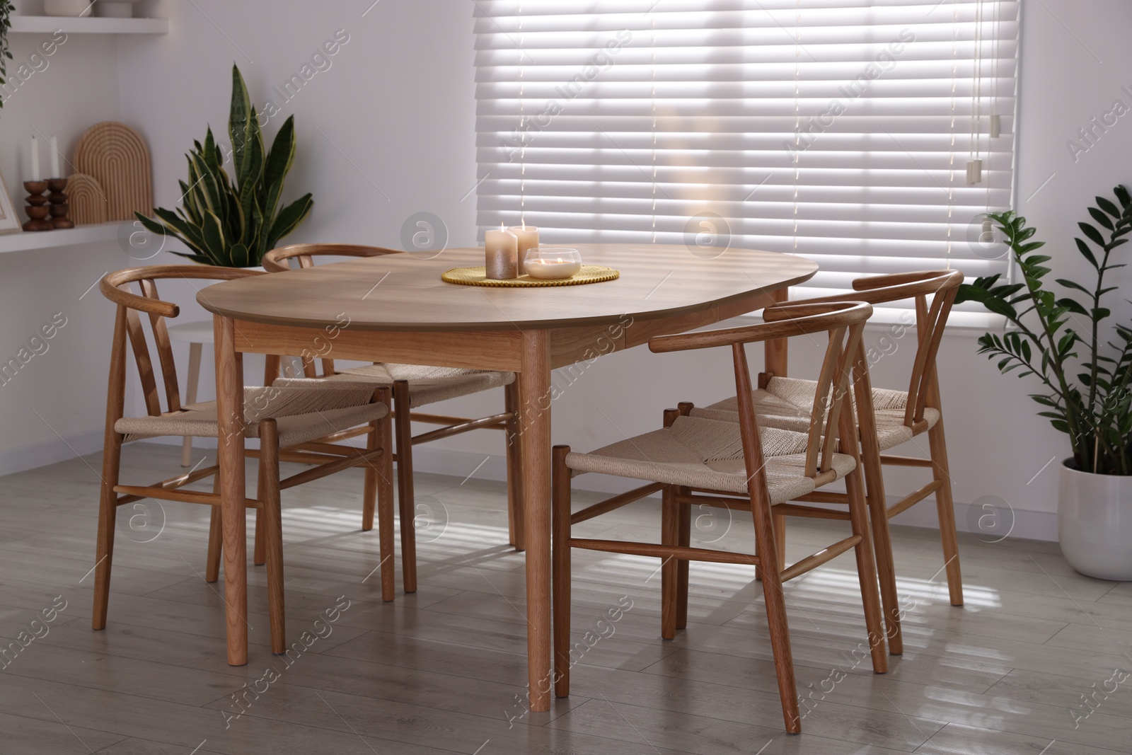 Photo of Stylish wooden table with chairs and decor indoors. Interior design