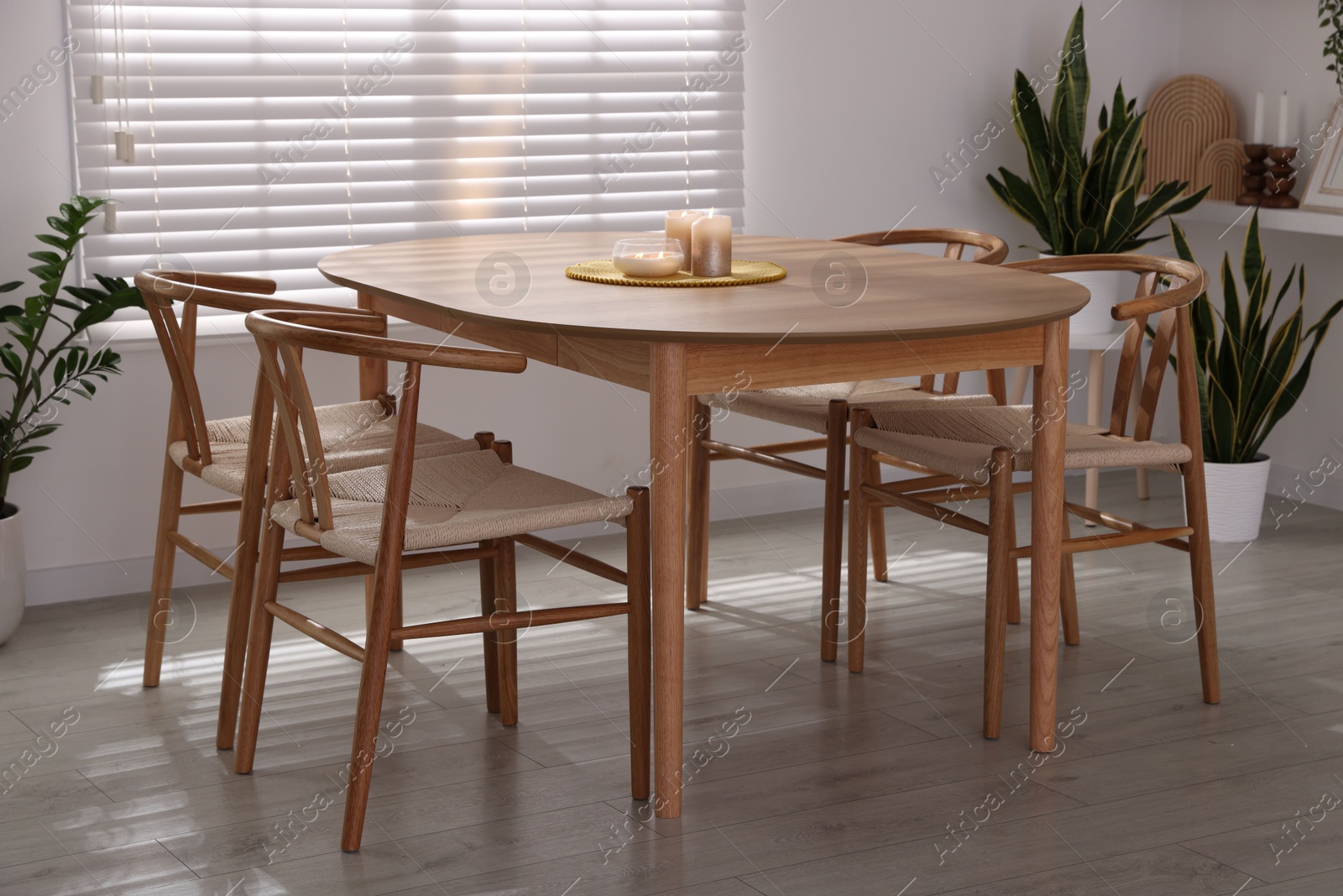 Photo of Stylish wooden table with chairs and decor indoors. Interior design