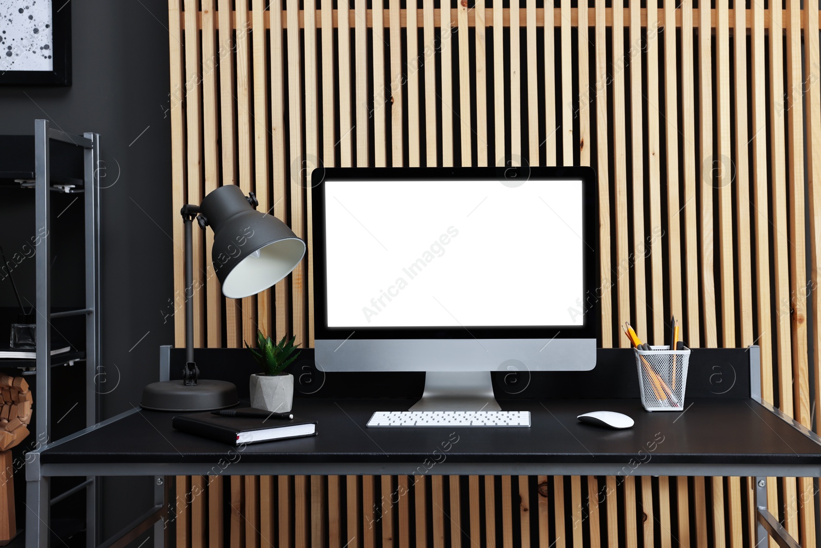 Photo of Comfortable workplace with modern computer on black table indoors