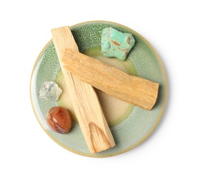 Photo of Palo santo sticks and gemstones isolated on white, top view