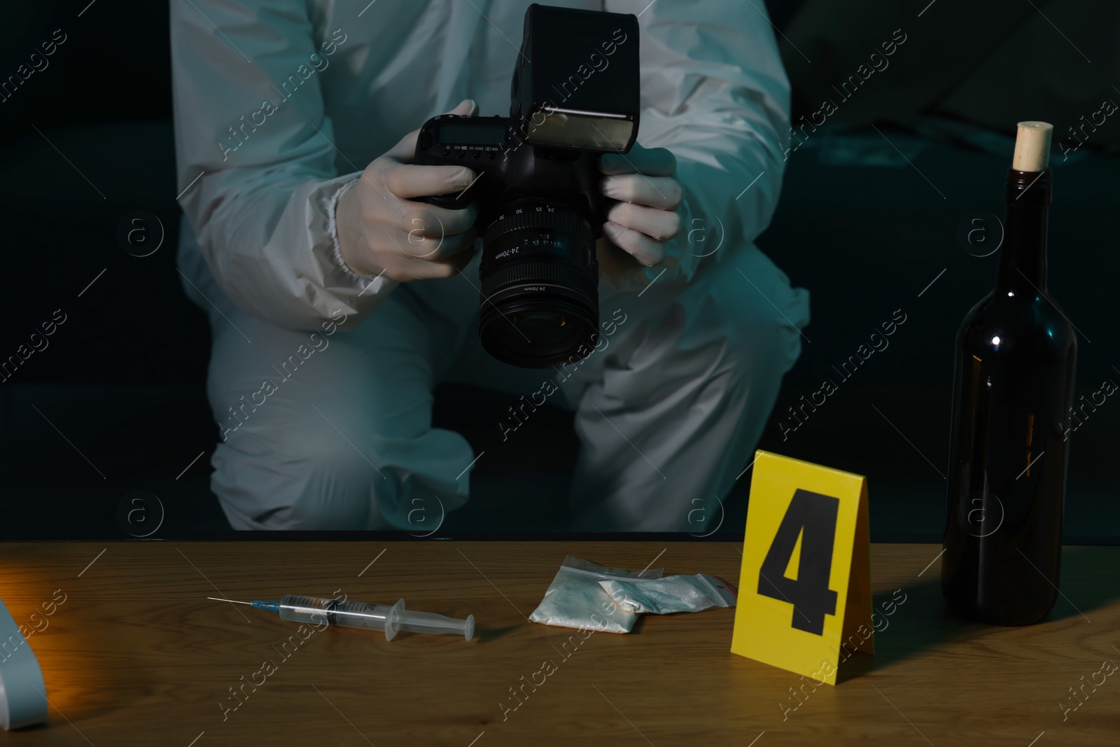 Photo of Forensic expert with camera taking photo of evidences at crime scene indoors, closeup