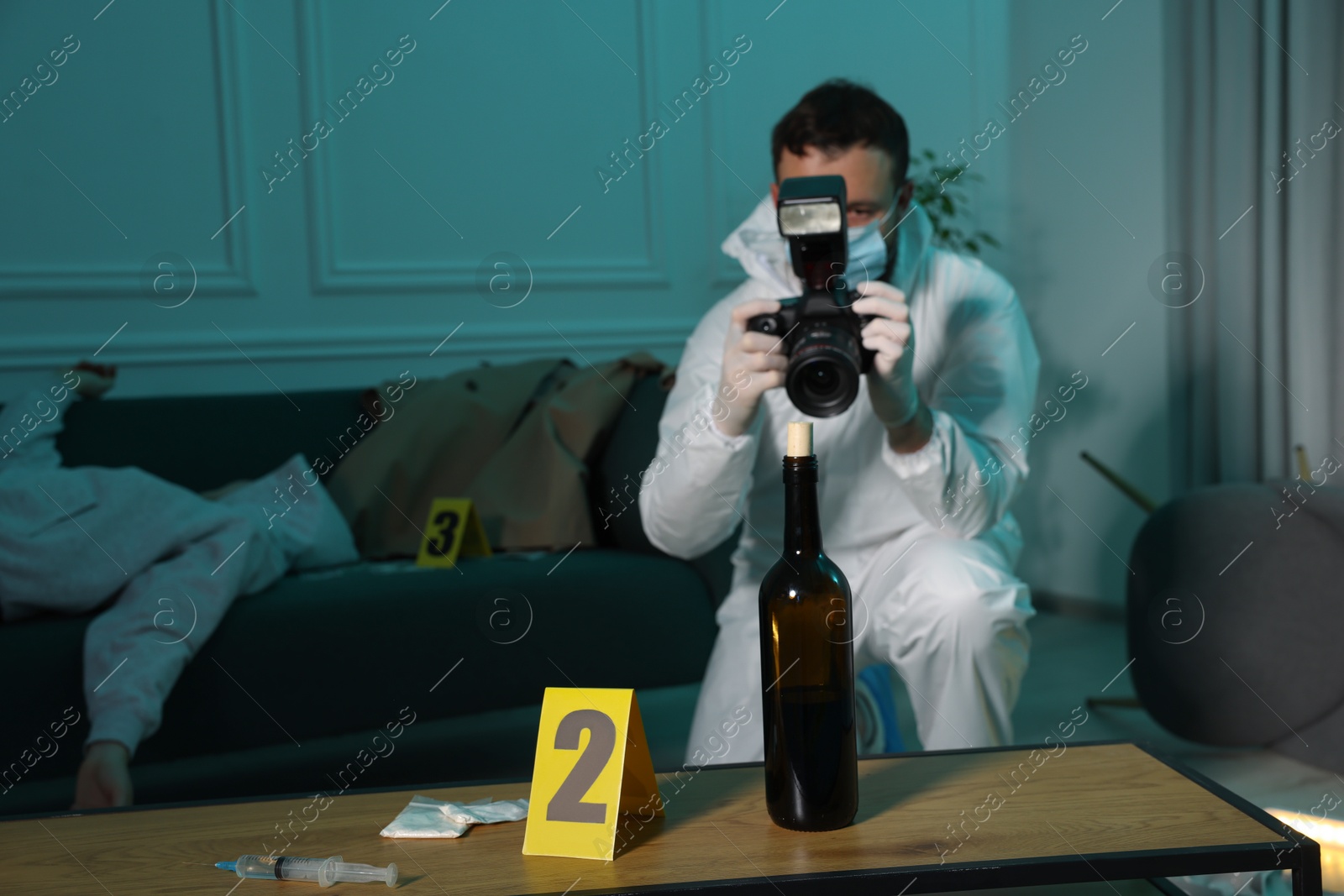 Photo of Forensic expert with camera working at crime scene and dead woman's body indoors