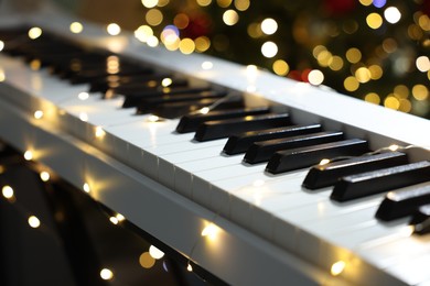 Photo of Electric piano against blurred lights, closeup. Bokeh effect