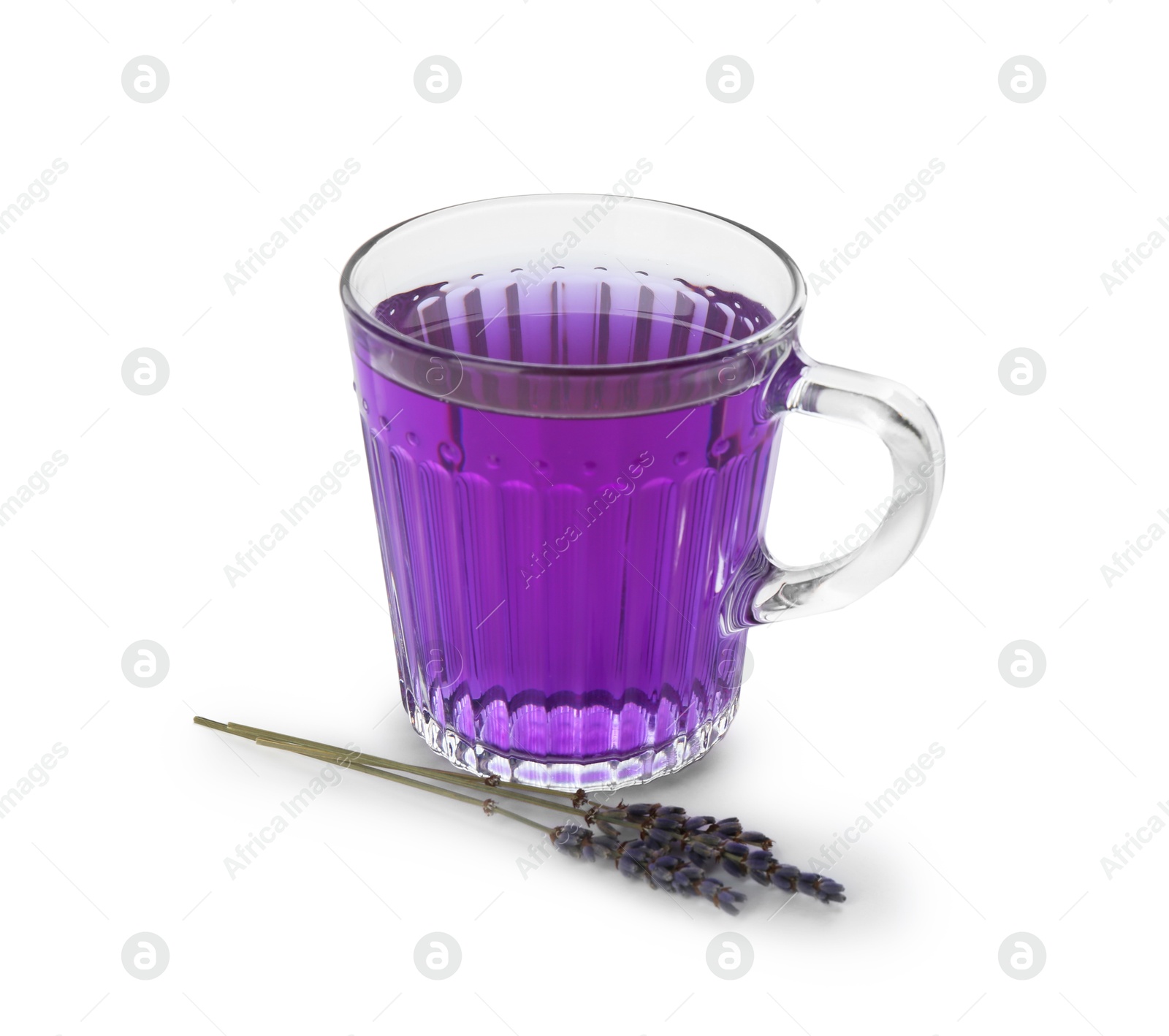 Photo of Aromatic lavender tea in glass cup and dry flowers isolated on white