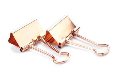 Photo of Two golden binder clips isolated on white