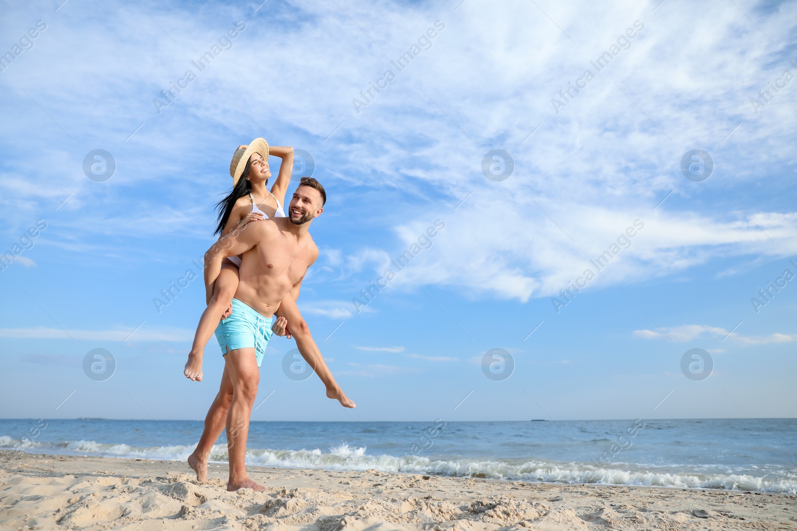 Photo of Happy young couple having fun on beach