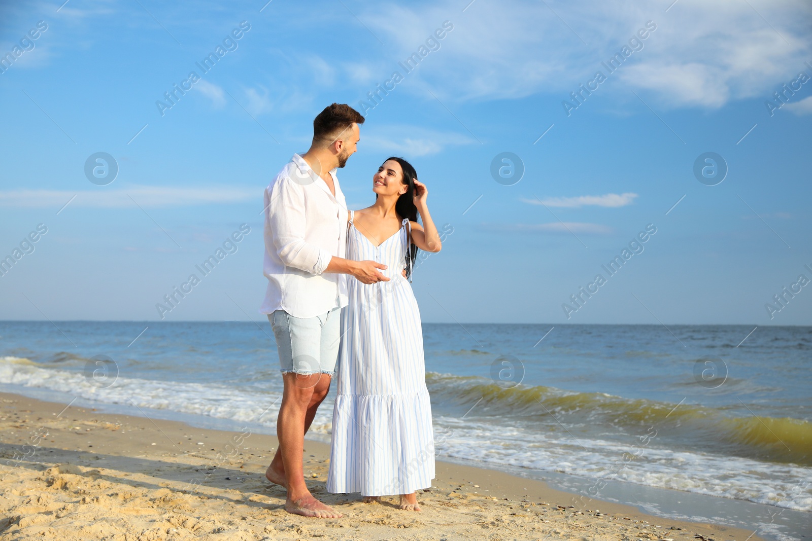 Photo of Happy young couple at beach on sunny day