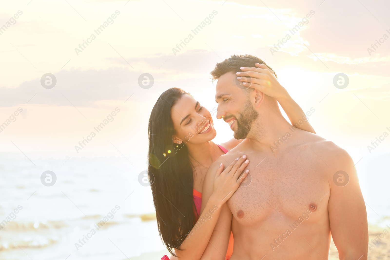 Photo of Happy young couple on beach on sunny day