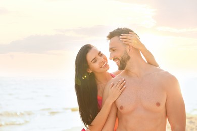 Photo of Happy young couple on beach on sunny day