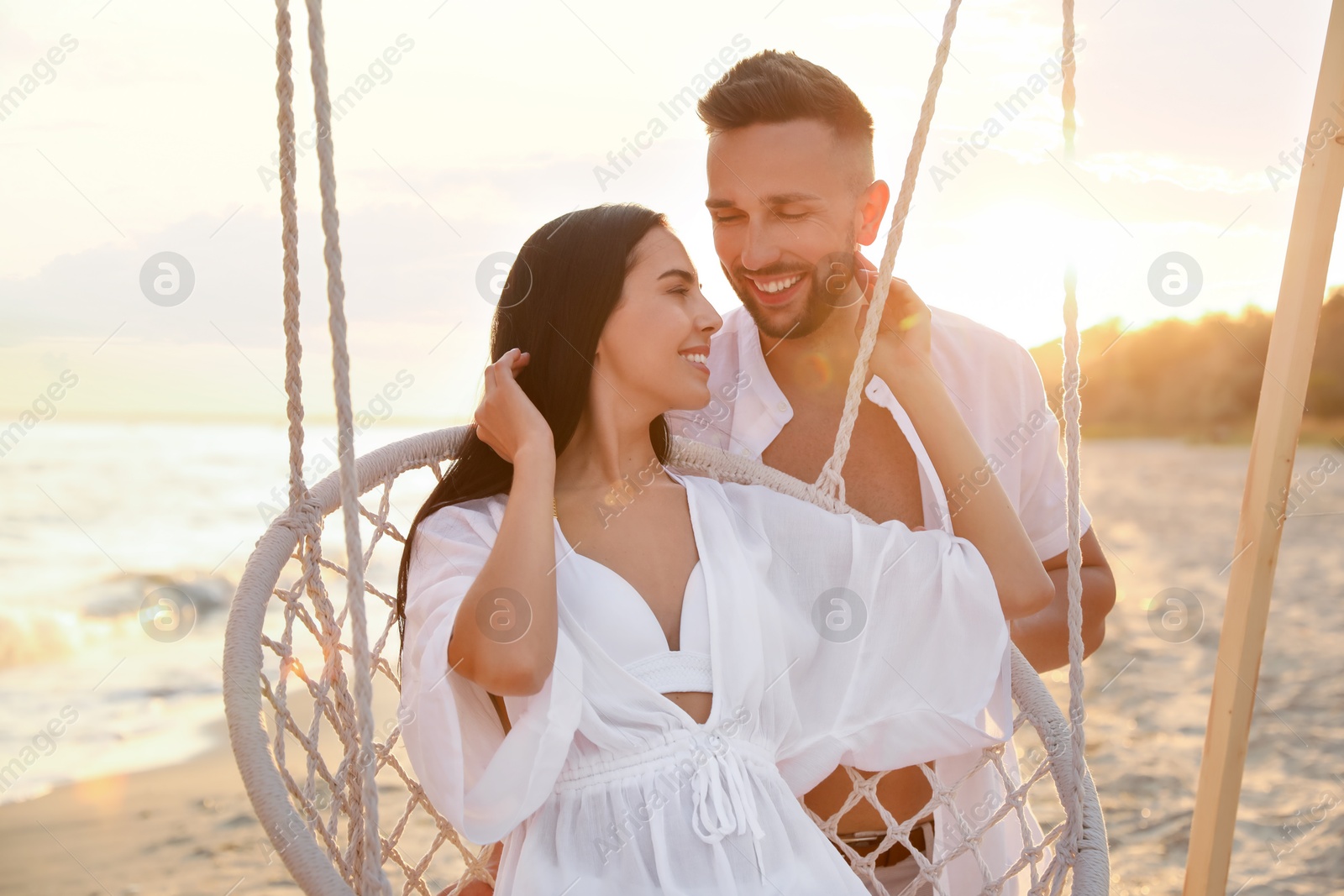 Photo of Happy young couple on beach at sunset