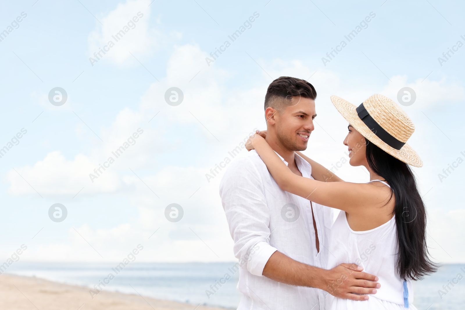 Photo of Lovely couple spending time together on beach. Space for text