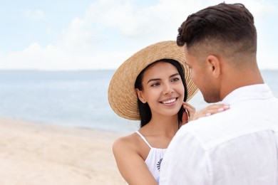 Photo of Lovely couple spending time together on beach