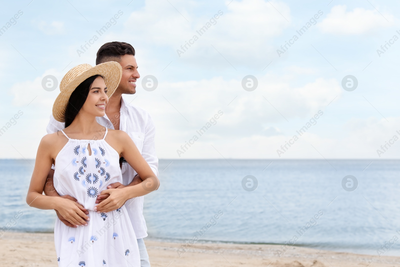 Photo of Lovely couple spending time together on beach. Space for text