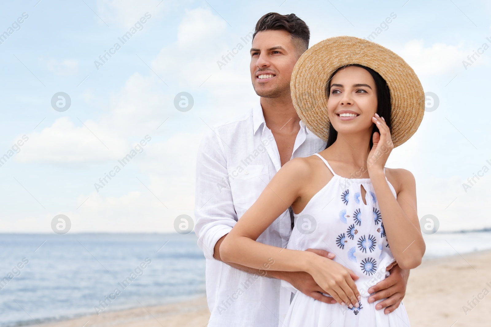 Photo of Lovely couple spending time together on beach. Space for text