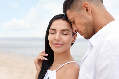 Photo of Lovely couple spending time together on beach