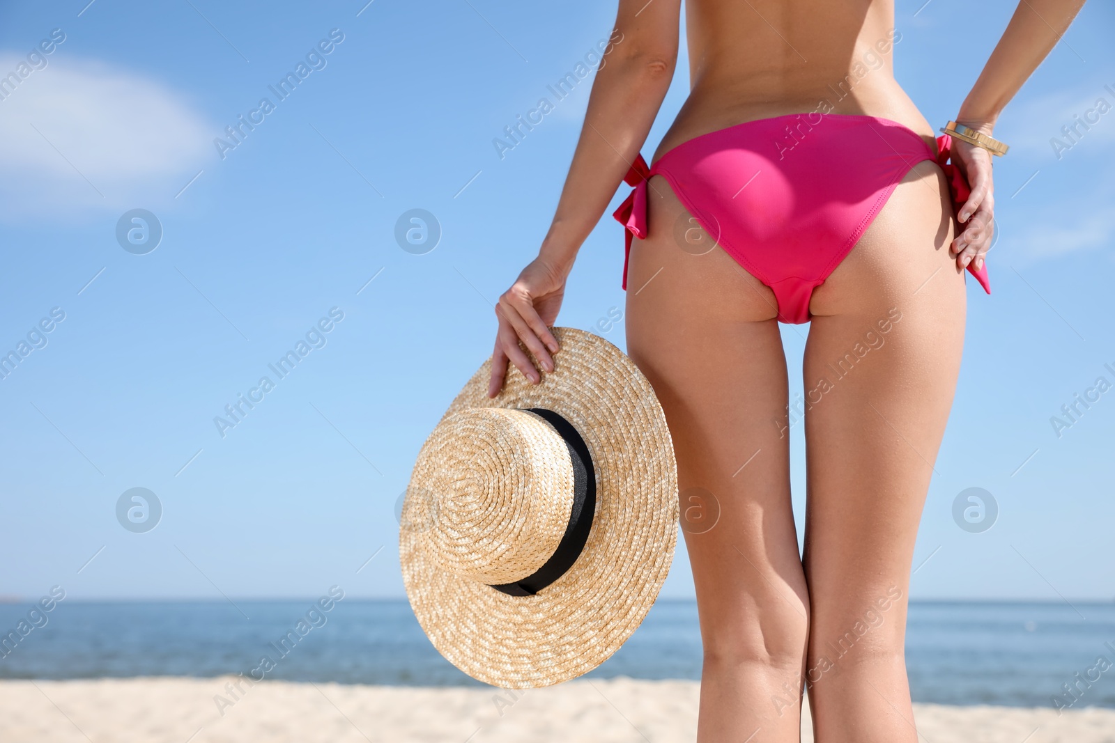 Photo of Young woman with beautiful body on beach, closeup