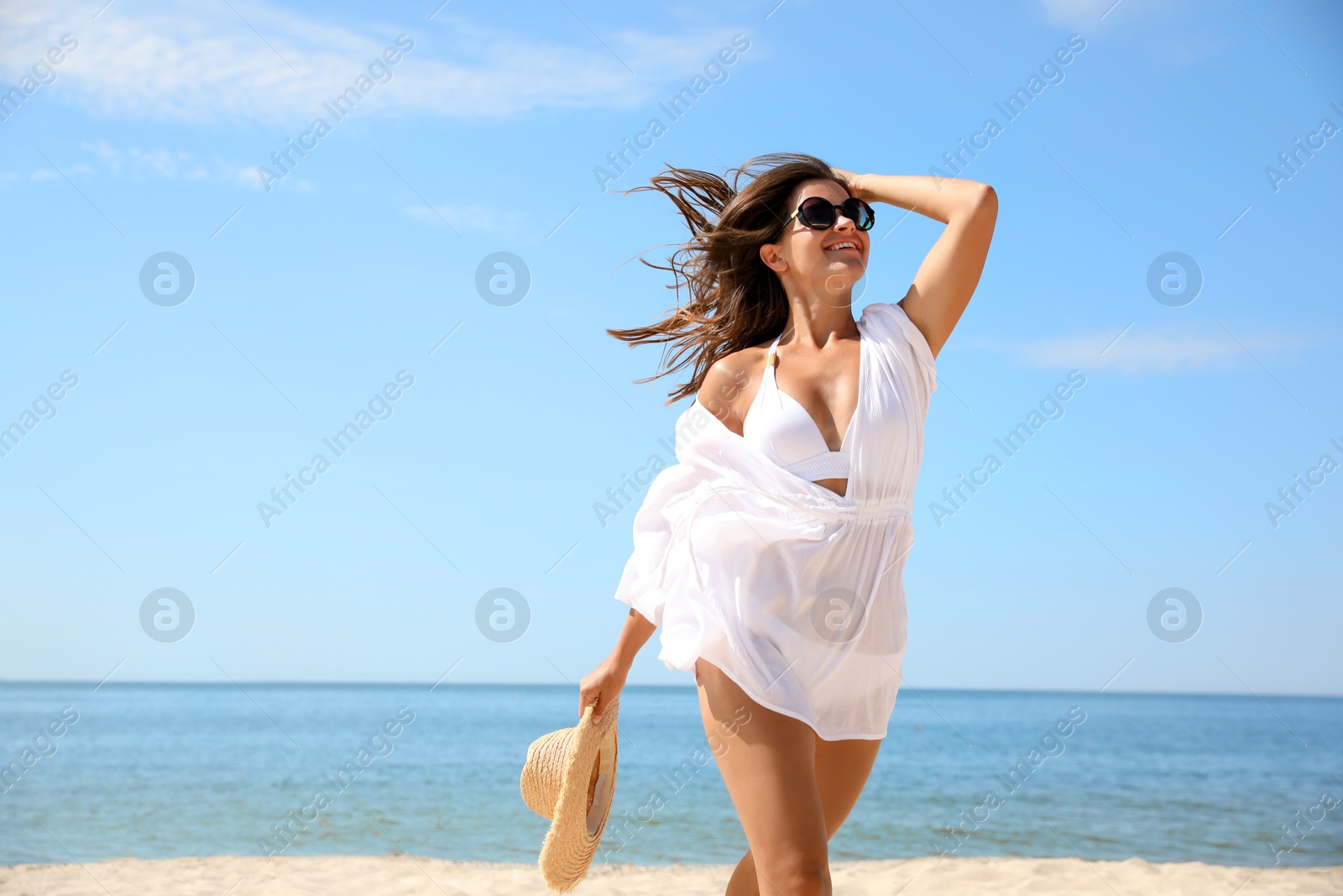 Photo of Young woman with beautiful body on beach