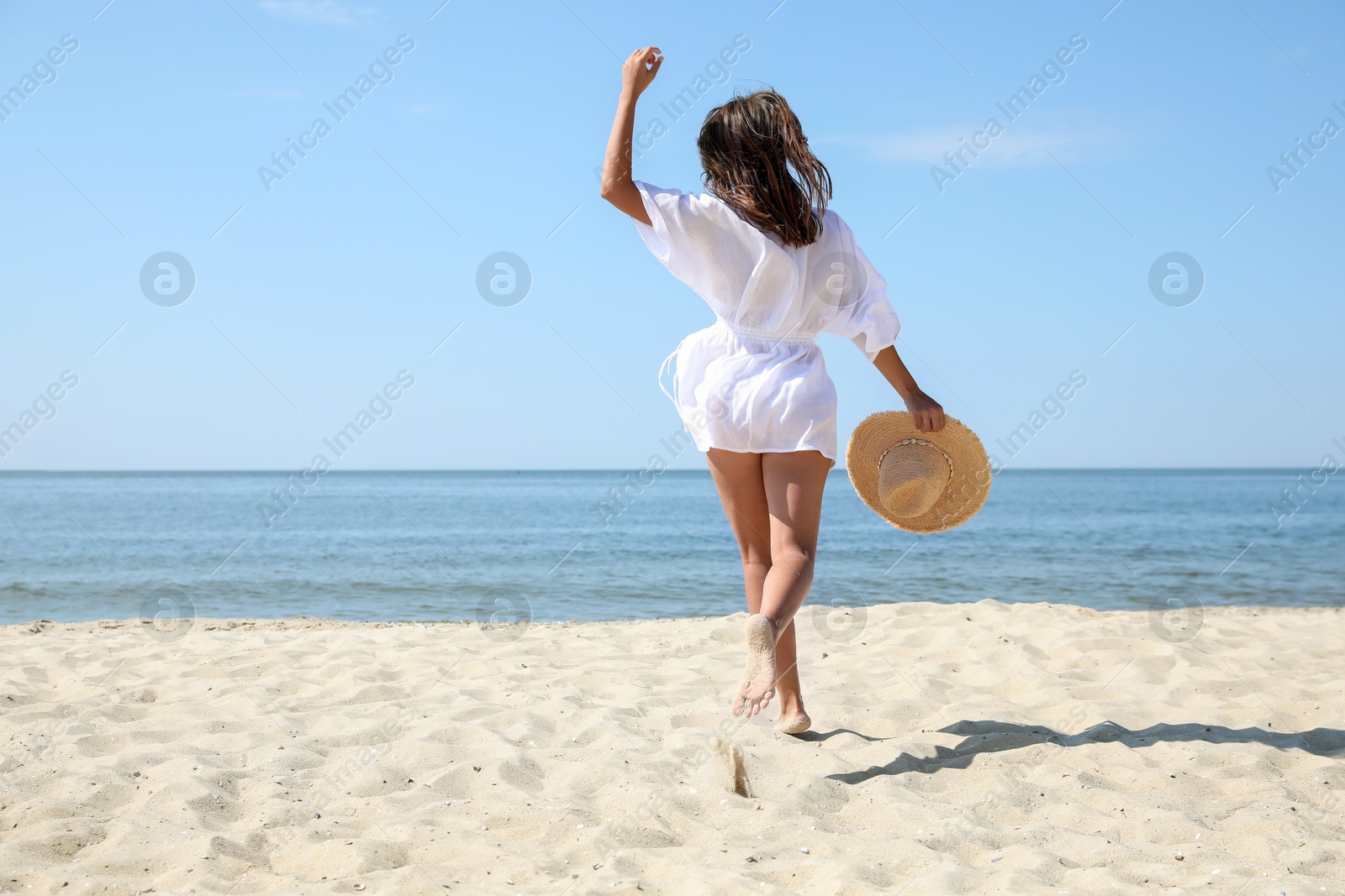 Photo of Young woman with beautiful body on sandy beach. Space for text