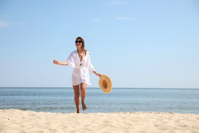 Photo of Young woman with beautiful body on sandy beach. Space for text