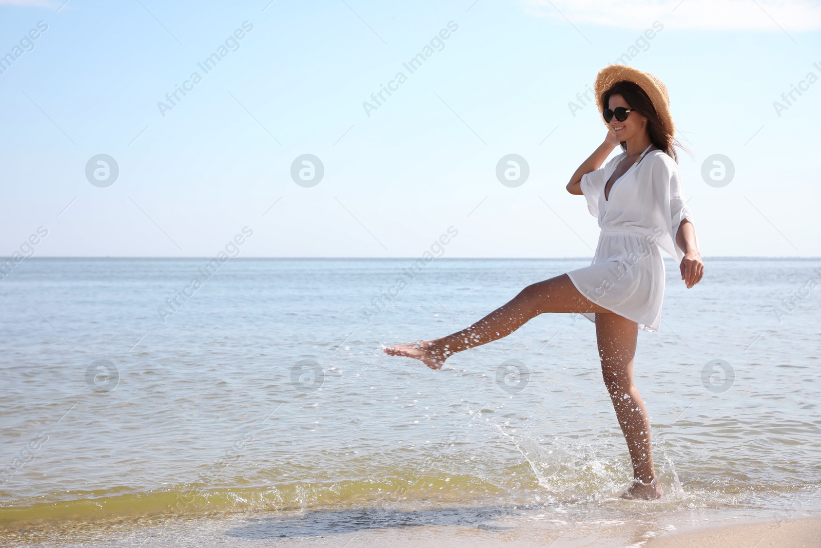 Photo of Young woman with beautiful body on beach. Space for text