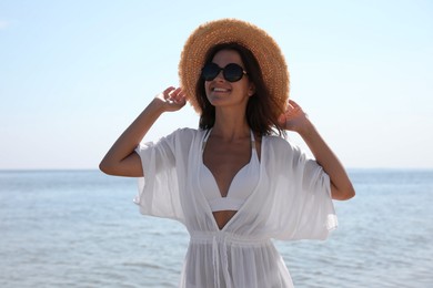 Photo of Young woman with beautiful body on beach