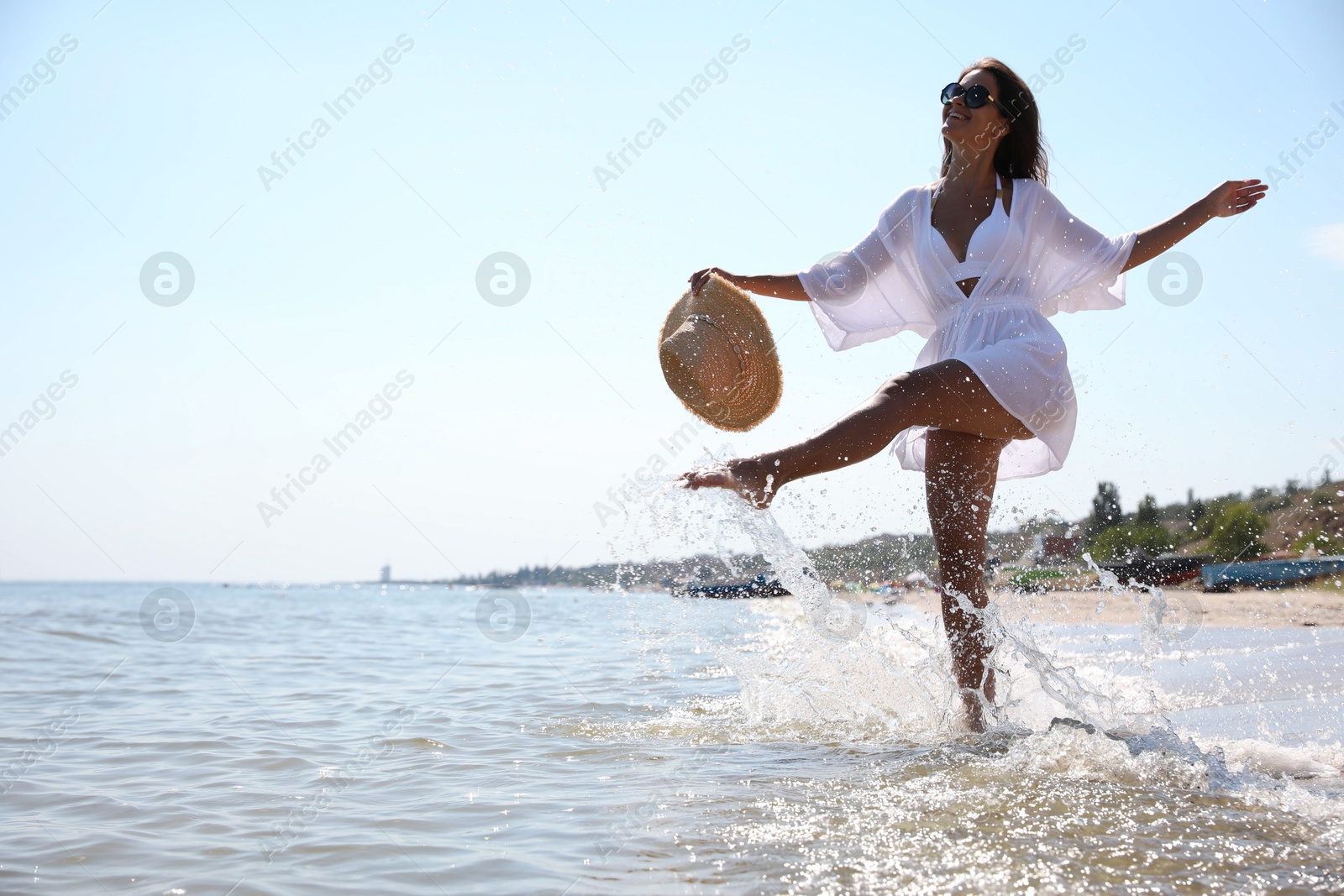 Photo of Young woman with beautiful body on beach. Space for text