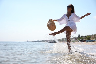 Photo of Young woman with beautiful body on beach. Space for text