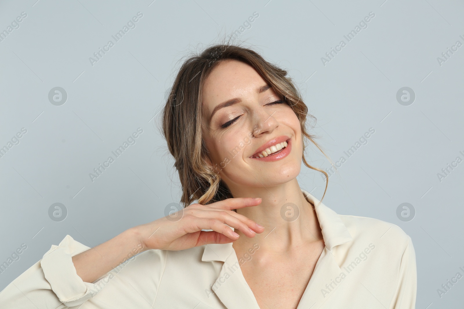 Photo of Young woman with beautiful hairstyle on light grey background