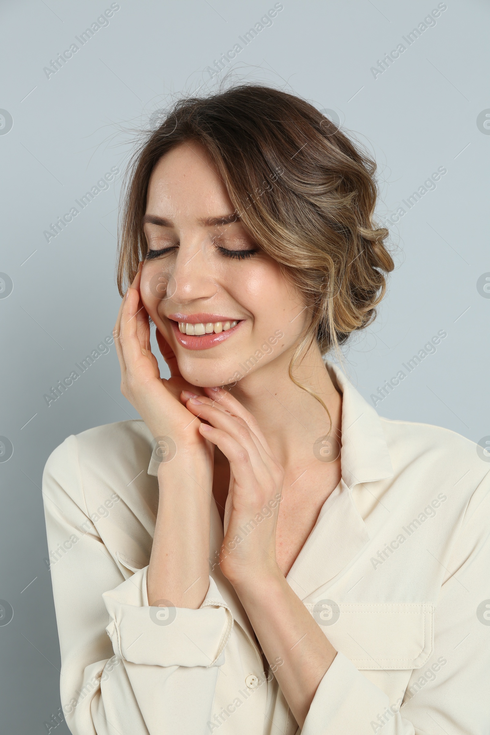 Photo of Young woman with beautiful hairstyle on light grey background