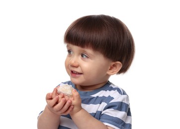 Photo of Cute little child eating tasty mochi on white background