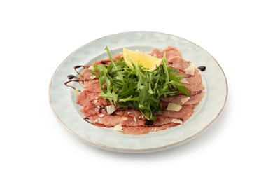 Delicious beef carpaccio with arugula, cheese, balsamic vinegar and lemon isolated on white