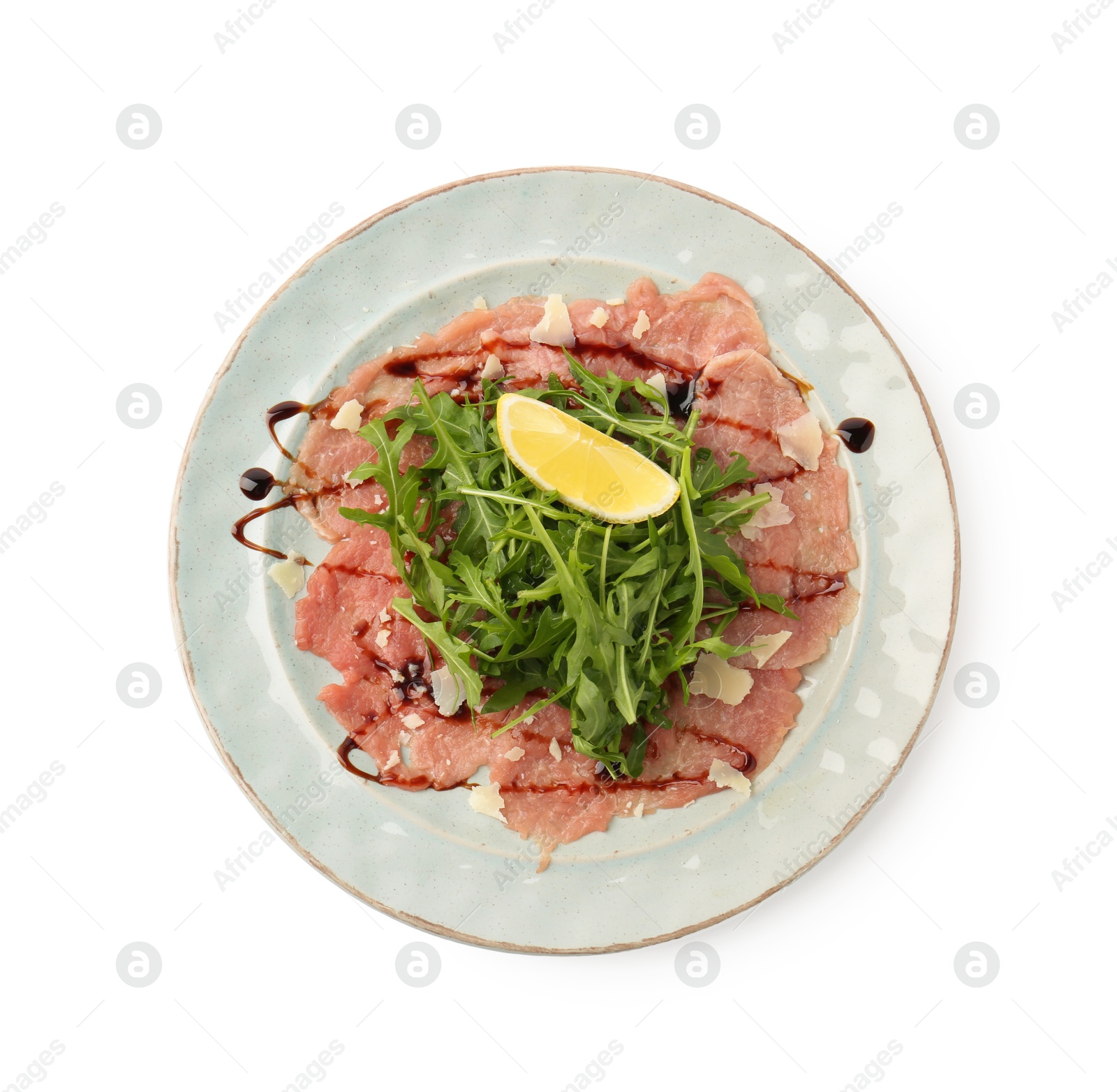 Photo of Delicious beef carpaccio with arugula, cheese, balsamic vinegar and lemon isolated on white, top view