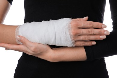 Photo of Woman with medical bandage on wrist against white background, closeup