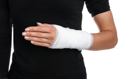 Photo of Woman with medical bandage on wrist against white background, closeup