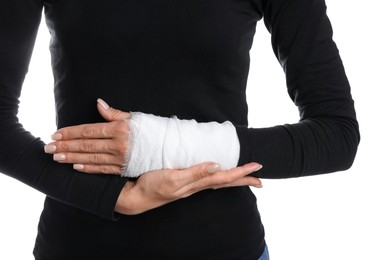 Photo of Woman with medical bandage on wrist against white background, closeup