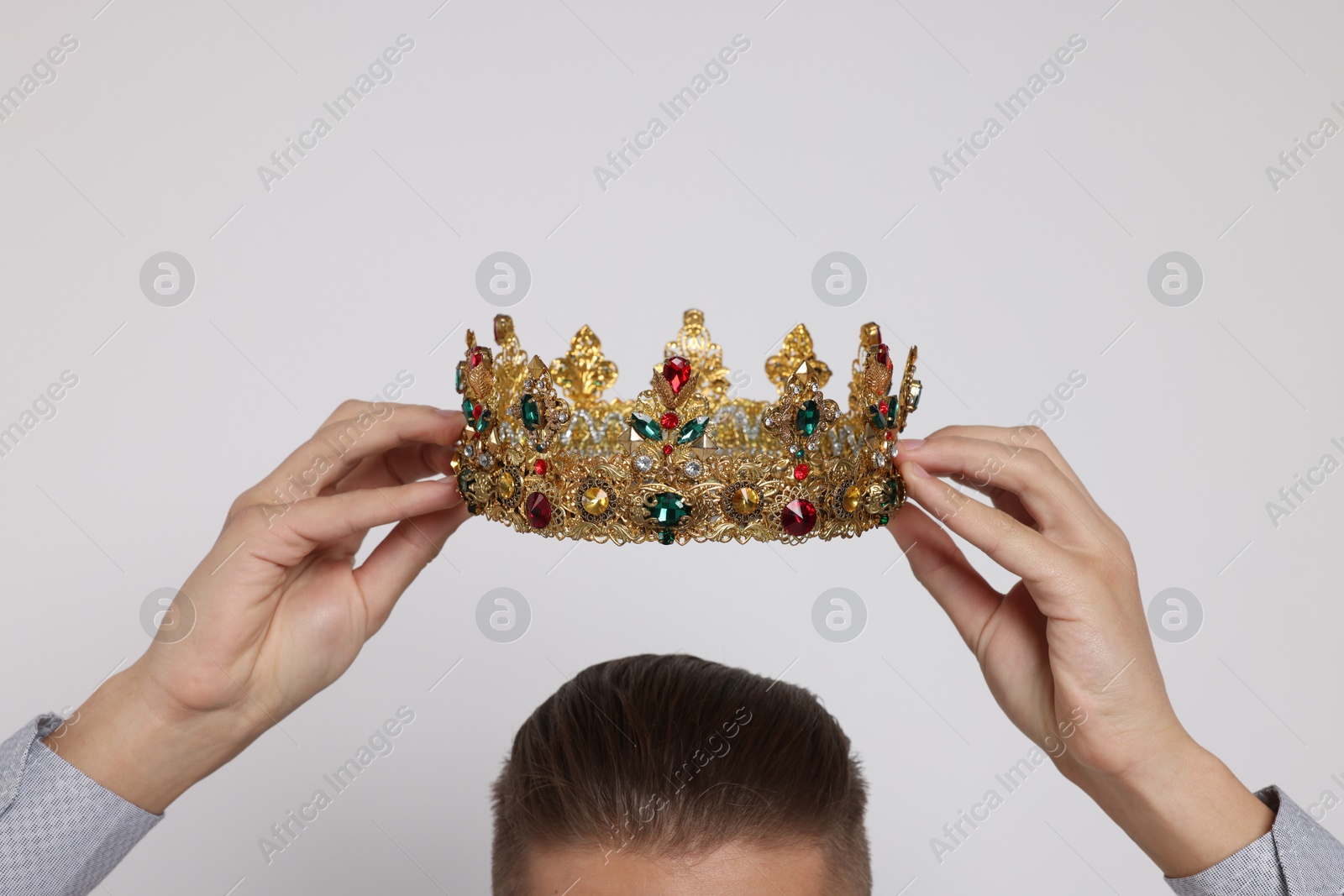 Photo of Man wearing luxury crown on white background, closeup